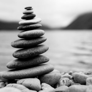 zen-balancing-pebbles-misty-lake_53876-138200